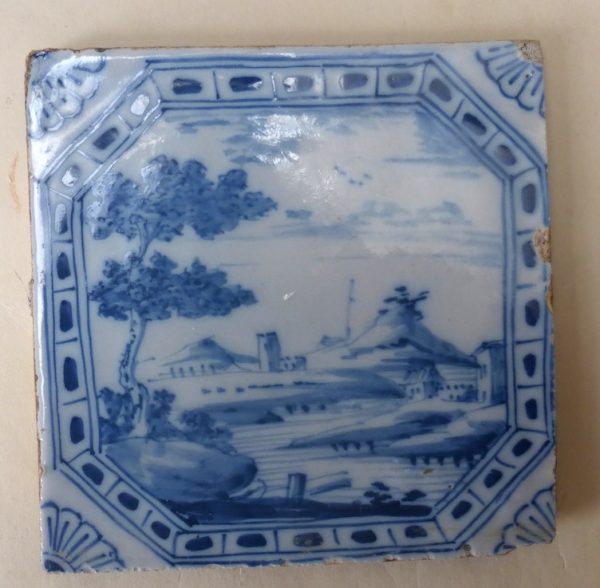 English Delft tile with a framed landscape scene London c1740-60 5 inches square